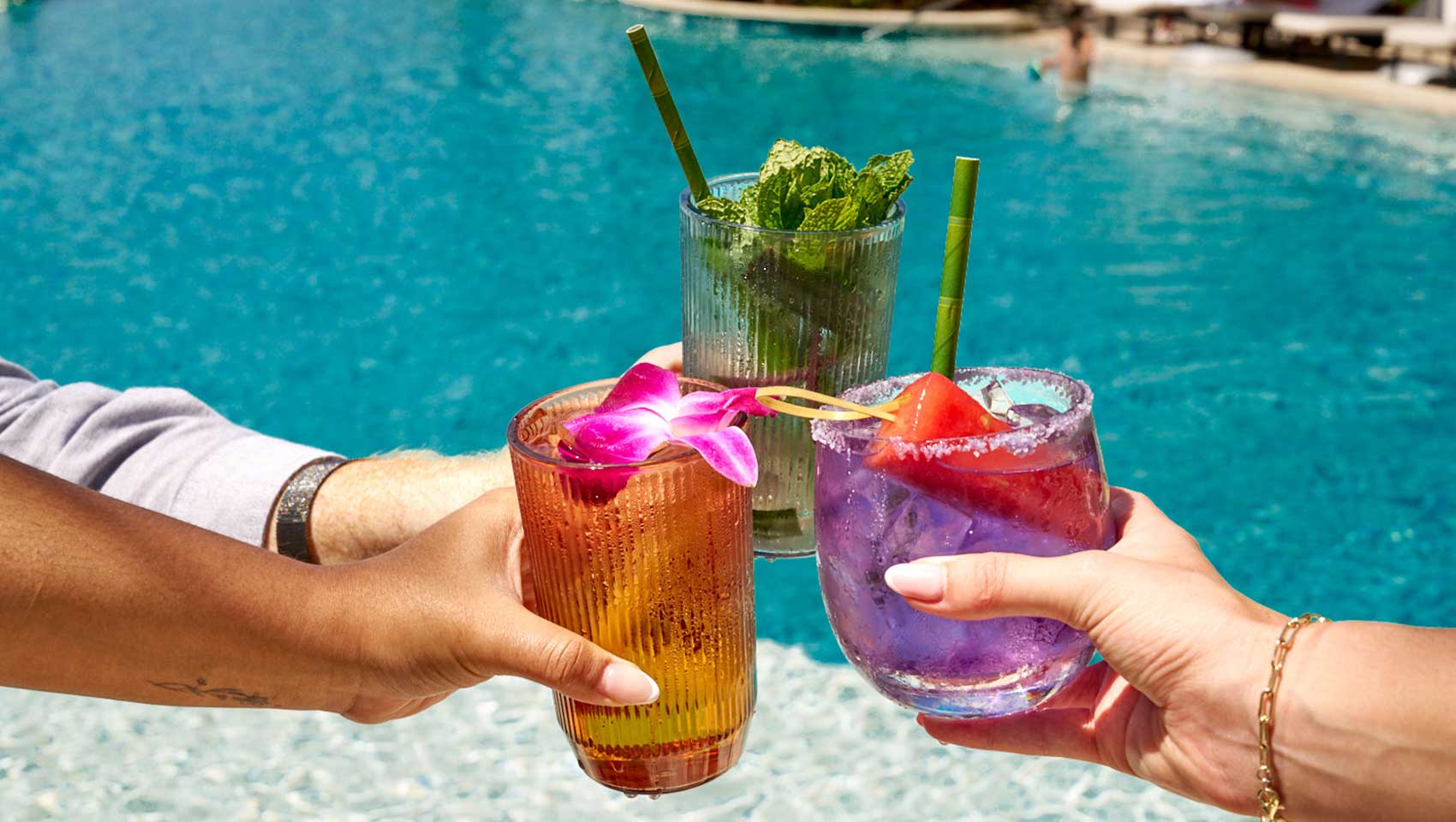 Colorful cocktail toast by the pool at Seafire Grand Cayman