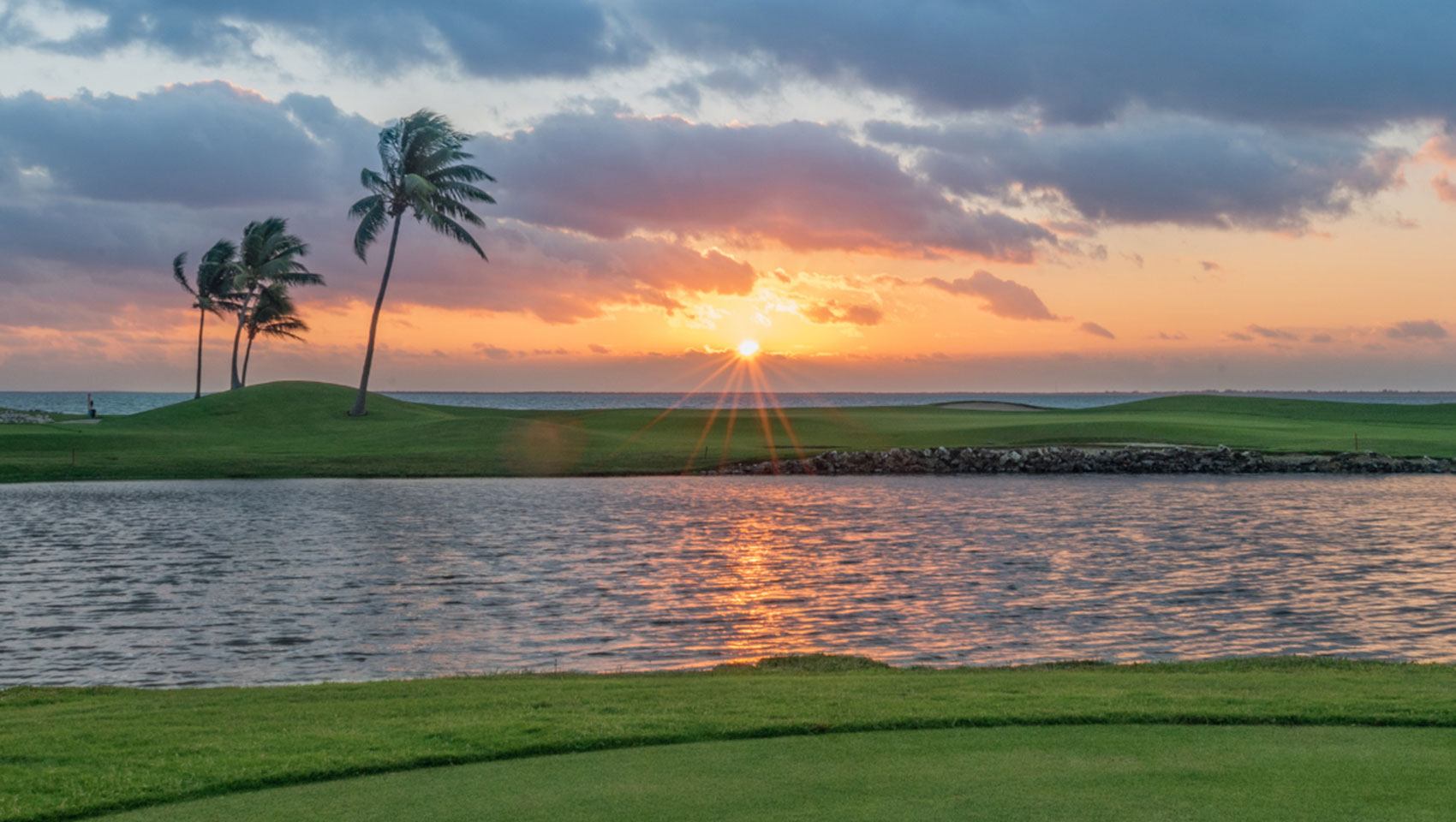 View of water trap with ocean in background at sunset