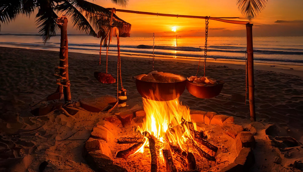 pots of food cooking over a beach campfire