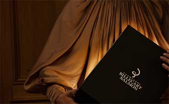 woman holding billecart salmon menu